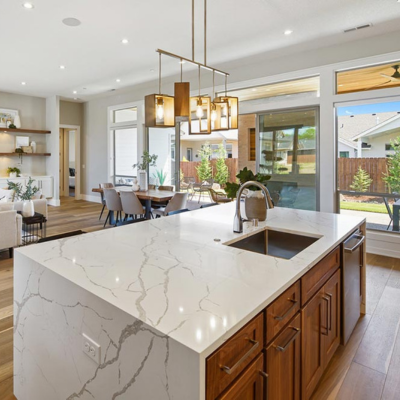 Open-concept kitchen with marble countertop kitchen island and dining area.